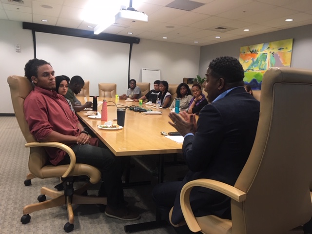 Calvin Butler talks with students around the table