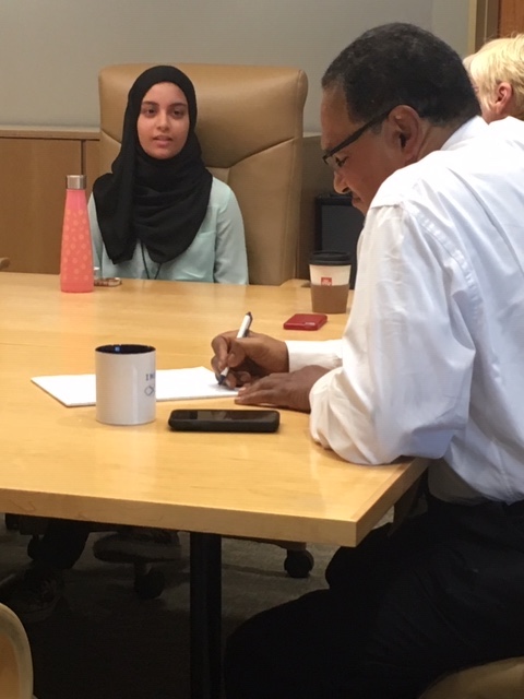 Freeman Hrabowski takes notes as Aiman Raza speaks