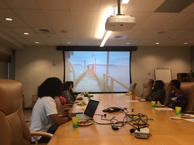 Amanda Lawrence shows a slide of her on a dock doing research