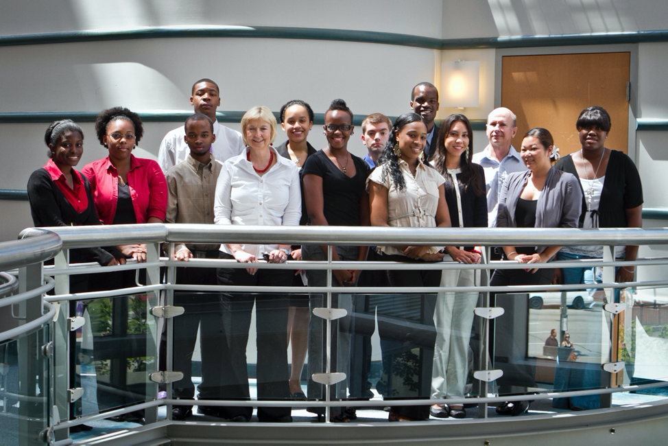 group of 14 people posing for a photo - 12 interns and 2 advisors