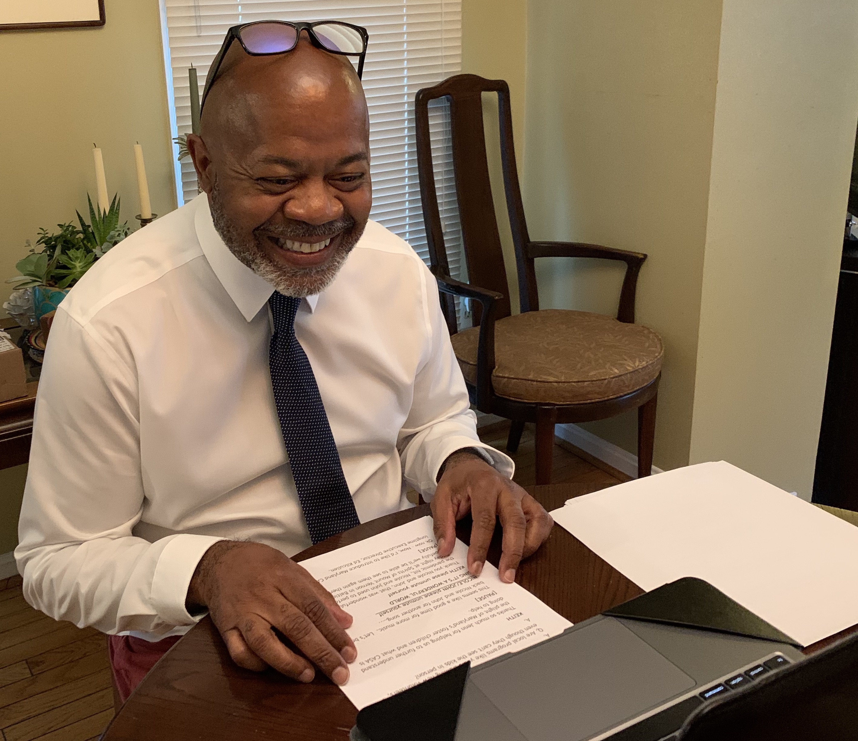 Keith Snipes sits in front of his computer with notes