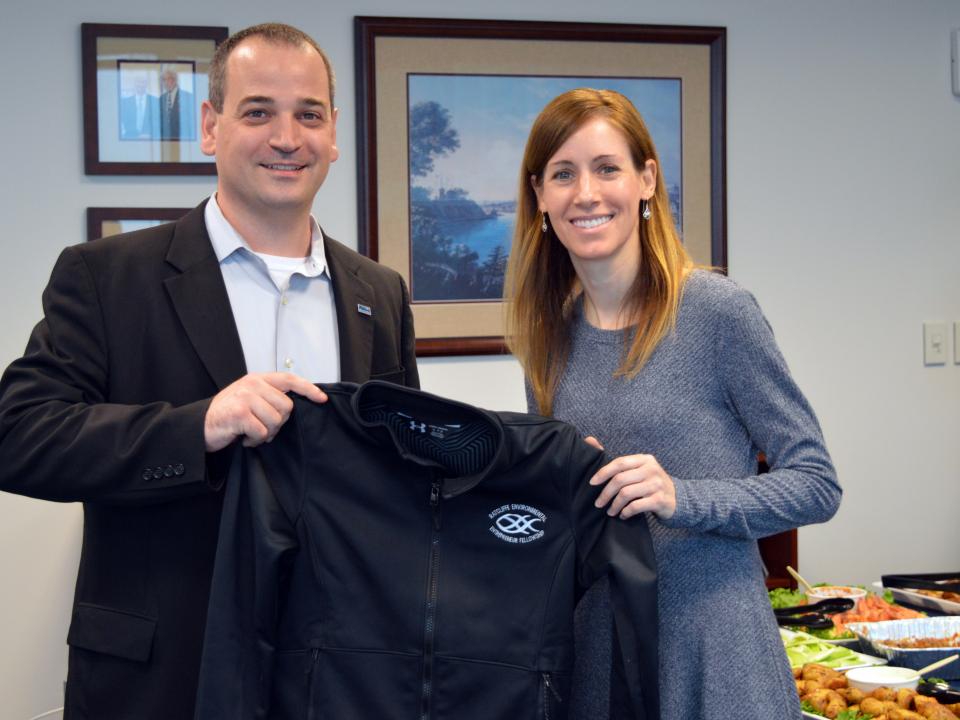 Mary Larkin receives her REEF jacket from Nicholas Hammond. 