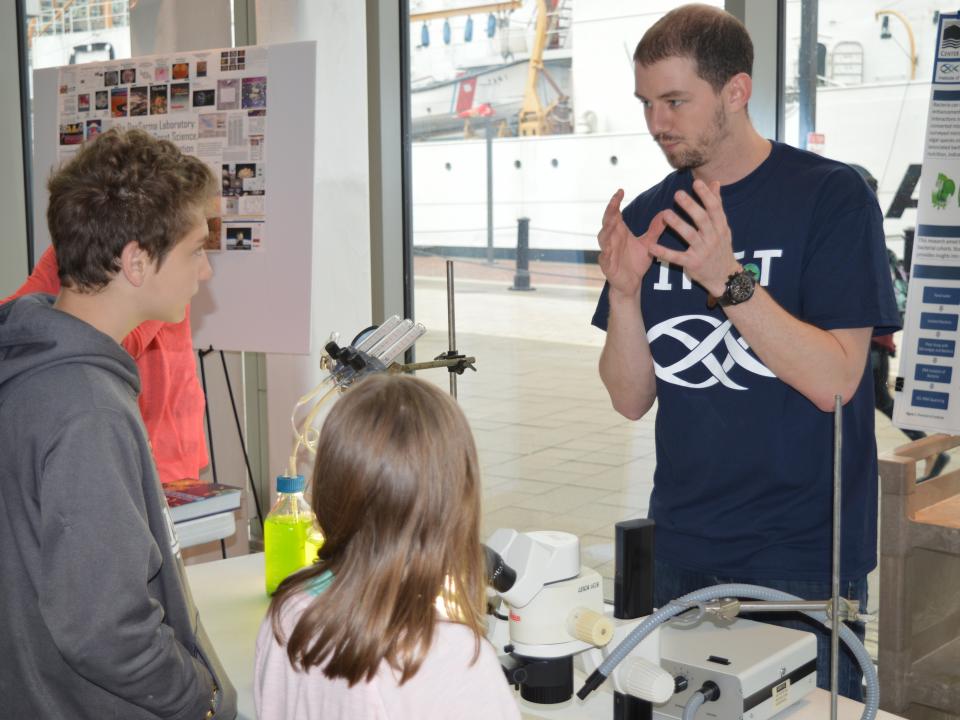 Sam Major talks about his research at IMET during the Open House. 