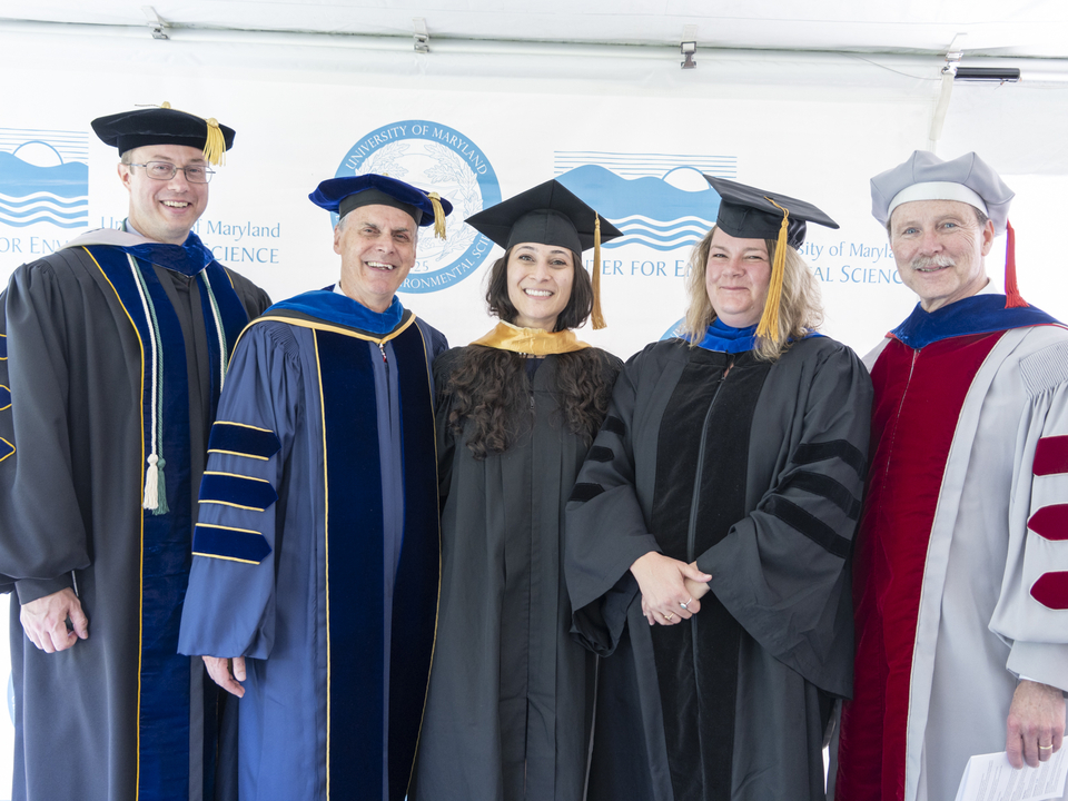 A group of mentors and students at commencement