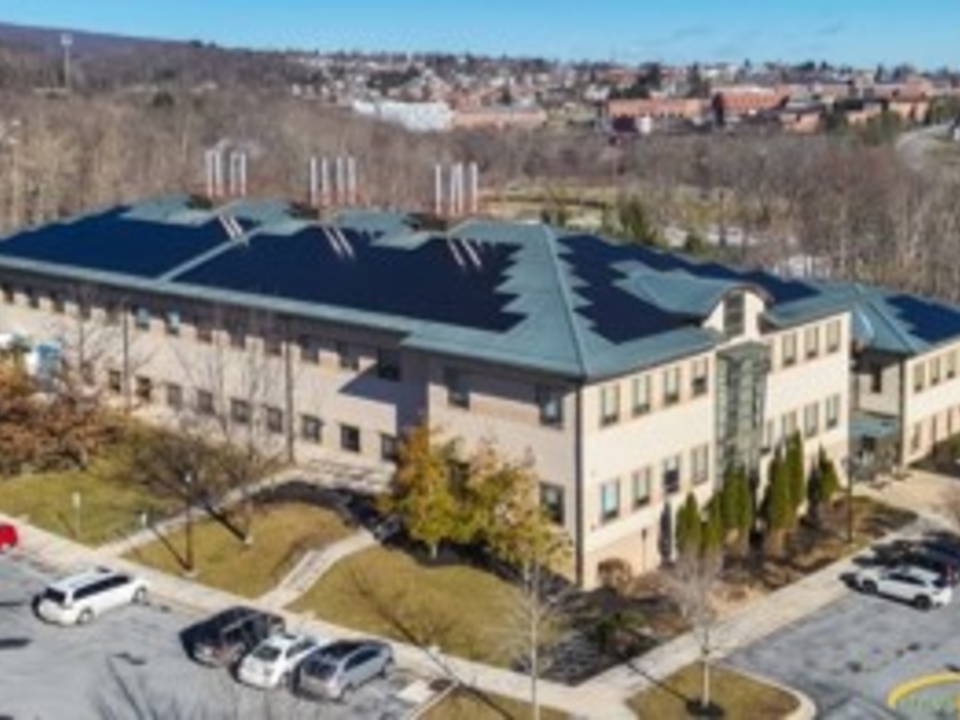 Aerial photo of UMCES Appalachian Laboratory with solar panels installed on roof. Frostburg State Campus can be seen in the background. 