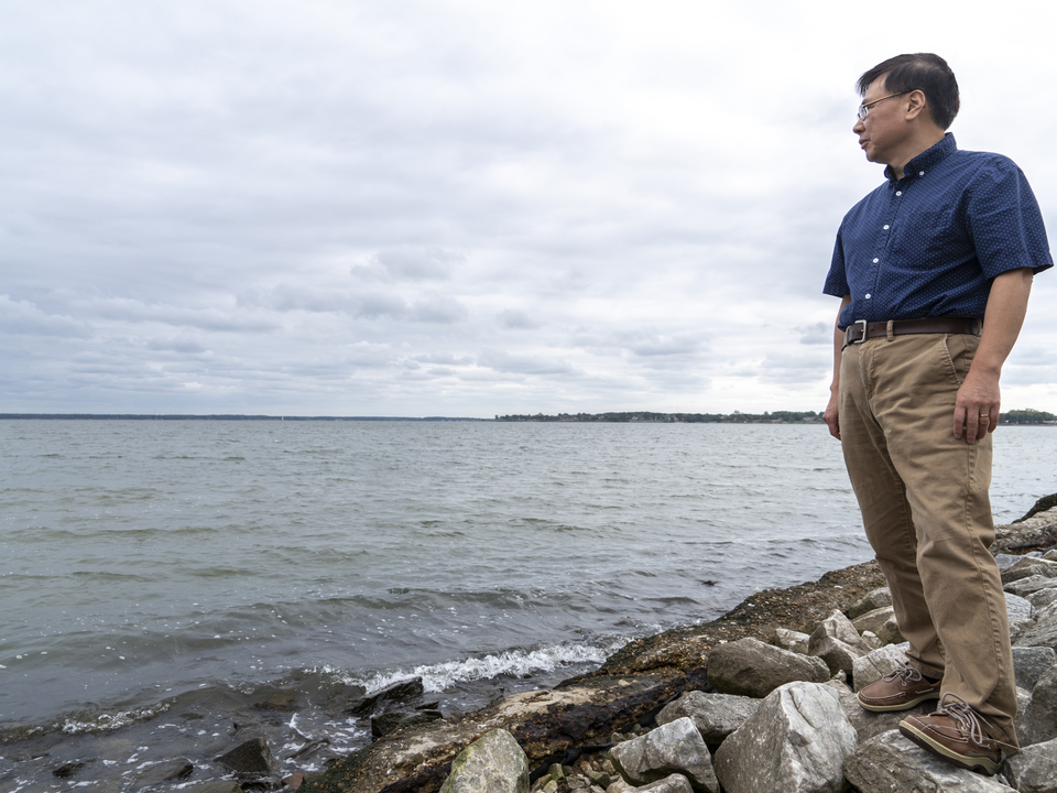 Coastal scientist Ming Li stands along the shoreline of the Choptank River