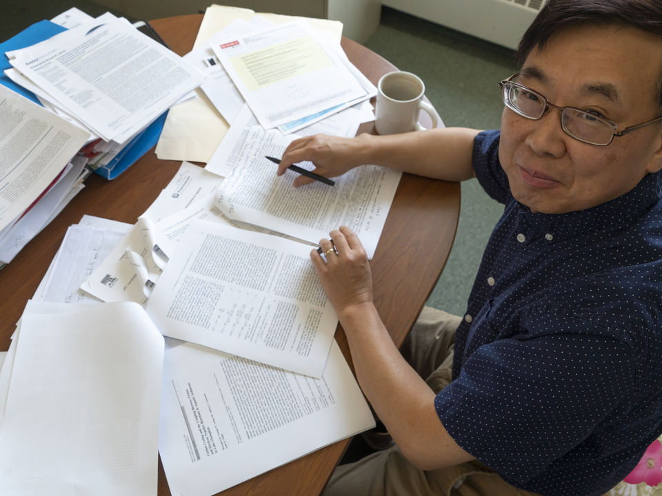 Ming Li at his desk