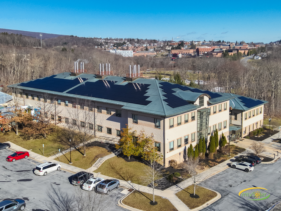 Aerial photo of AL building with solar panels on roof in view. Frostburg State campus can be seen in the background. 