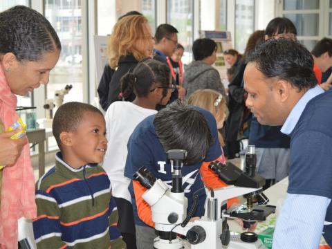 A guest at the IMET Open House talks to Shailendra Singh about algae and biodiesel. 