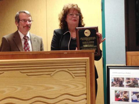 Janice Keene, president of the Evergreen Heritage Center Foundation, accepts the 2015 Richard A. Johnson Environmental Education Award as Appalachian Laboratory Director Eric Davidson looks on.