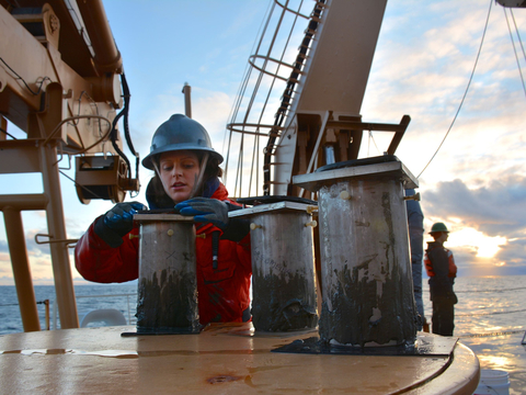 Chelsea Wegner with scientific equipment aboard an arctic research vessel