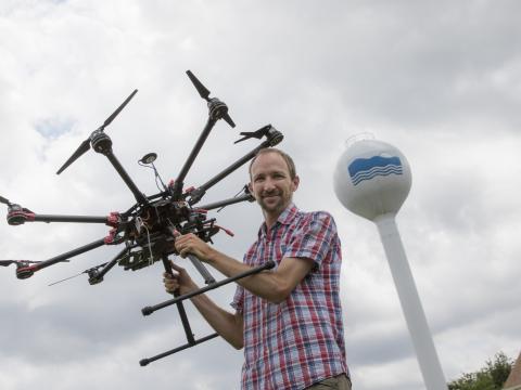 Greg Silsbe with a drone in front of Horn Point Laboratory's water tower