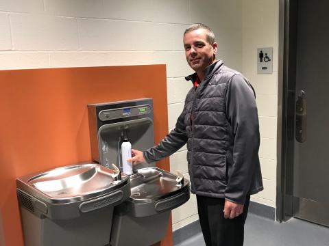 Brian Duke fills up a refillable water bottle at a new water filling station on campus.