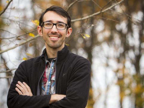 Andrew Gougherty standing in a forest. 