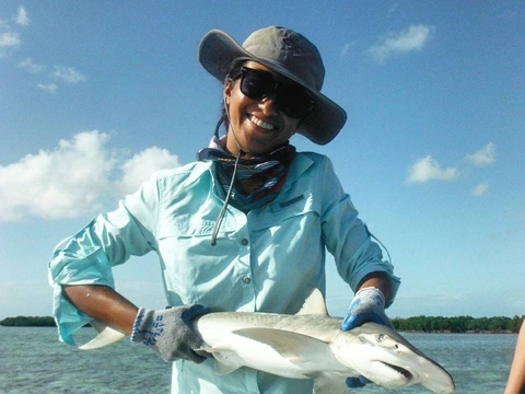 Samara holding a small reef shark