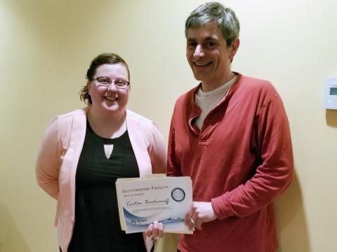 Tsetso Bachvaroff poses with the certificate he received from Kaila Noland and the other graduate students. 