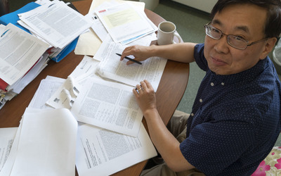 Ming Li at his desk