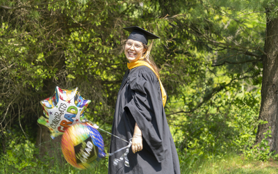 Graduate student holding a balloon
