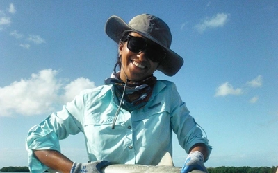 Samara Nehemiah holding a small reef shark
