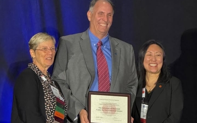 UMCES President Fernando Miralles-Wilhelm holds the certificate for the Coastal Stewardship Award.