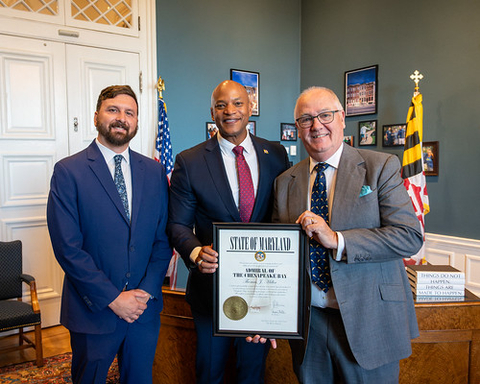 Maryland DNR Secretary Josh Kurtz and Governor Wes Moore present Professor Thomas Miller with the ‘Admiral of the Chesapeake Bay’ Award.