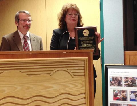 Janice Keene, president of the Evergreen Heritage Center Foundation, accepts the 2015 Richard A. Johnson Environmental Education Award as Appalachian Laboratory Director Eric Davidson looks on.