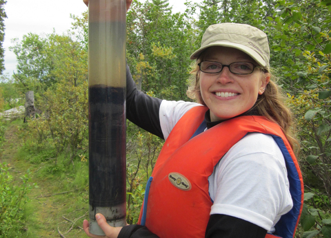 Grad student Hadley McIntosh holds up a soil sample in the field.