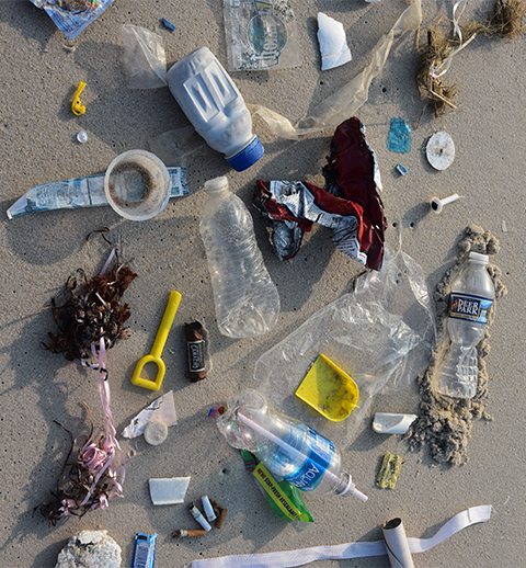 plastic waste on the beach sand