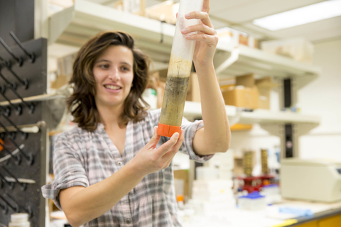 Emily Russ, a graduate student at Horn Point, holds up a sample of sediment. Photo by Cheryl Nemazie