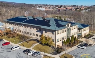 Aerial photo of UMCES Appalachian Laboratory with solar panels installed on roof. Frostburg State Campus can be seen in the background. 