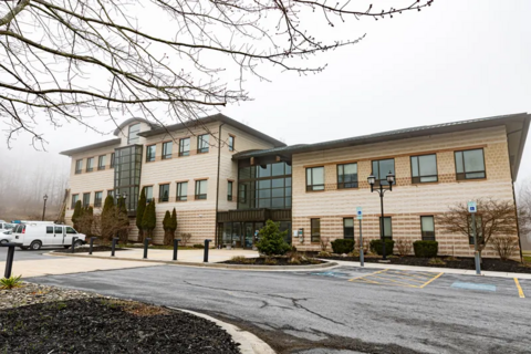 Front of Appalachian Laboratory light brown stone building with overcast background. 