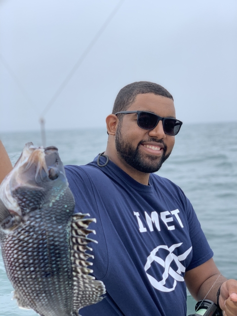 Ben Frey, alumnus of the IMET summer program holding a fish