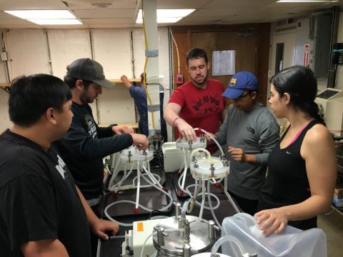 Nicholas Camacho, Dan Fucich, Jacob Dums (University of Delaware), Feng Chen and Ana Sosa collect samples of bacterial communities to identify back in Baltimore.