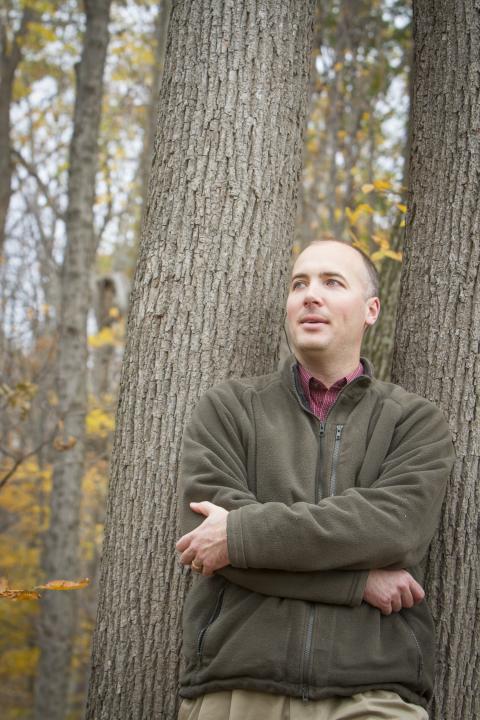 A portrait of Dave Nelson standing in a forest. Dave Nelson will be using stable forms of carbon, 12 and 13, to determine how much heat and drought stressed red spruce trees in different locations at different points in time. Photo by Cheryl Nemazie