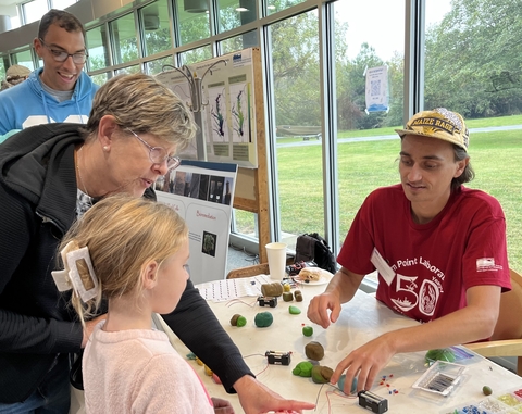 Photo of Horn Point Scientist speaking with a visiting family