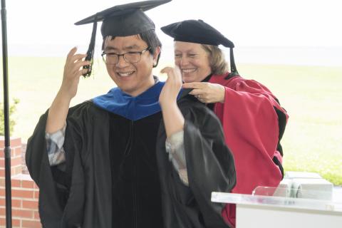 Graduate Fan Zhang is hooded by Professor Pat Glibert at UMCES' 2018 Commencement.