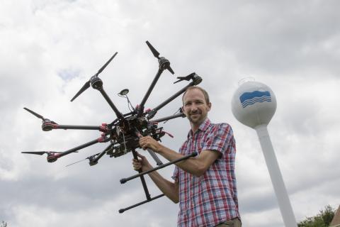 Greg Silsbe with a drone in front of Horn Point Laboratory's water tower