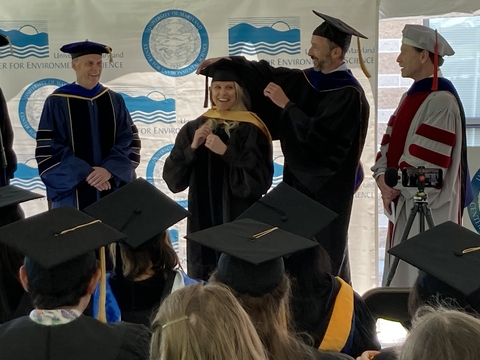 Anna Windle getting her hood at commencement