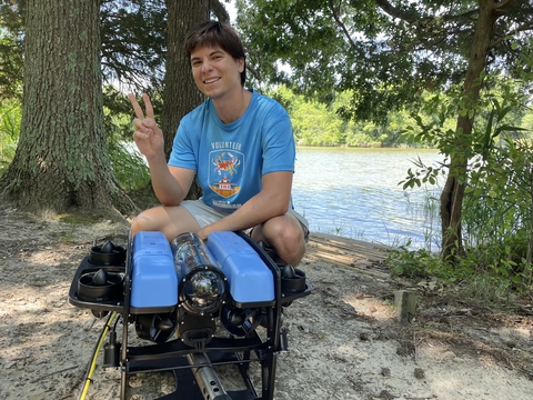 Alan Williams standing next to an ROV