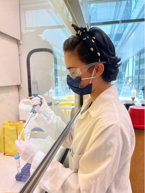 Intern Julia Moya pipetting a sample in the lab