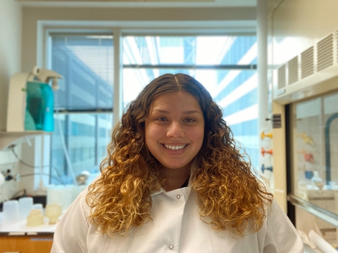 Olivia Pares in a lab coat in a lab