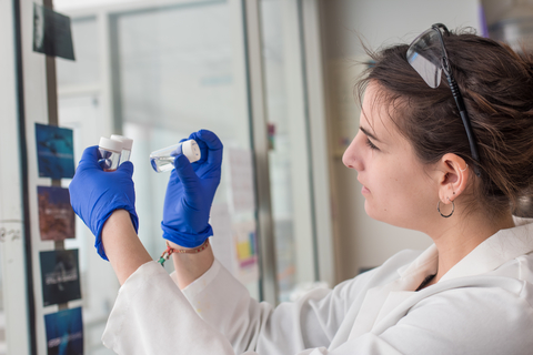 Lauren Jonas examining a petri dish in her lab