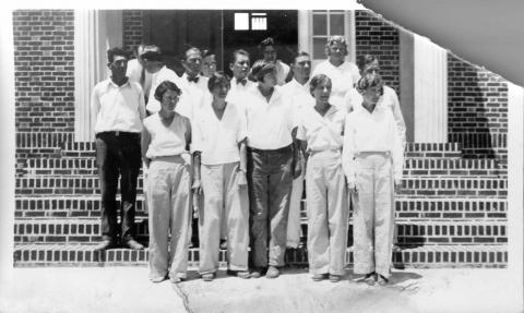 a group of people standing in front of library steps