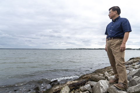 Coastal scientist Ming Li stands along the shoreline of the Choptank River