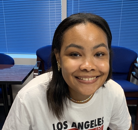 Makayla Stewart sitting in a chair smiling