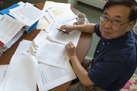 Ming Li at his desk