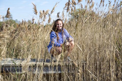 Graduate student Hannah Morrissette pictured in a research marsh