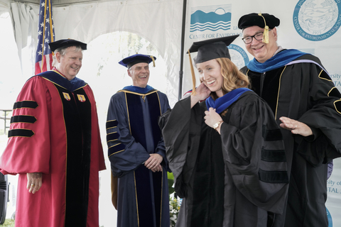 graduate student gets hooded by their advisor