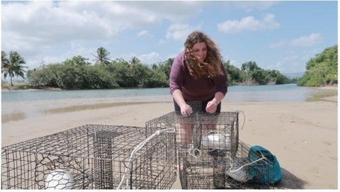 Image of Olivia Pares on beach with crab cages