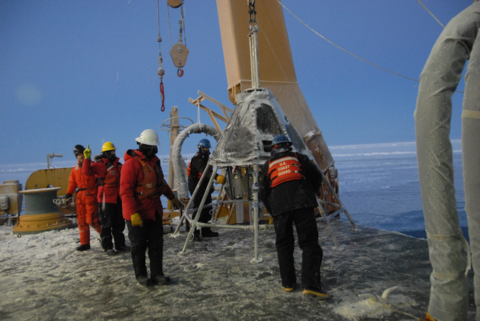 A sediment corer to collect samples from the seafloor is deployed from the stern of the Healy in subzero temperatures 